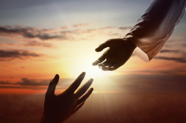 A hand reaching out to another person - pelvic health physiotherapy helping with prostate cancer